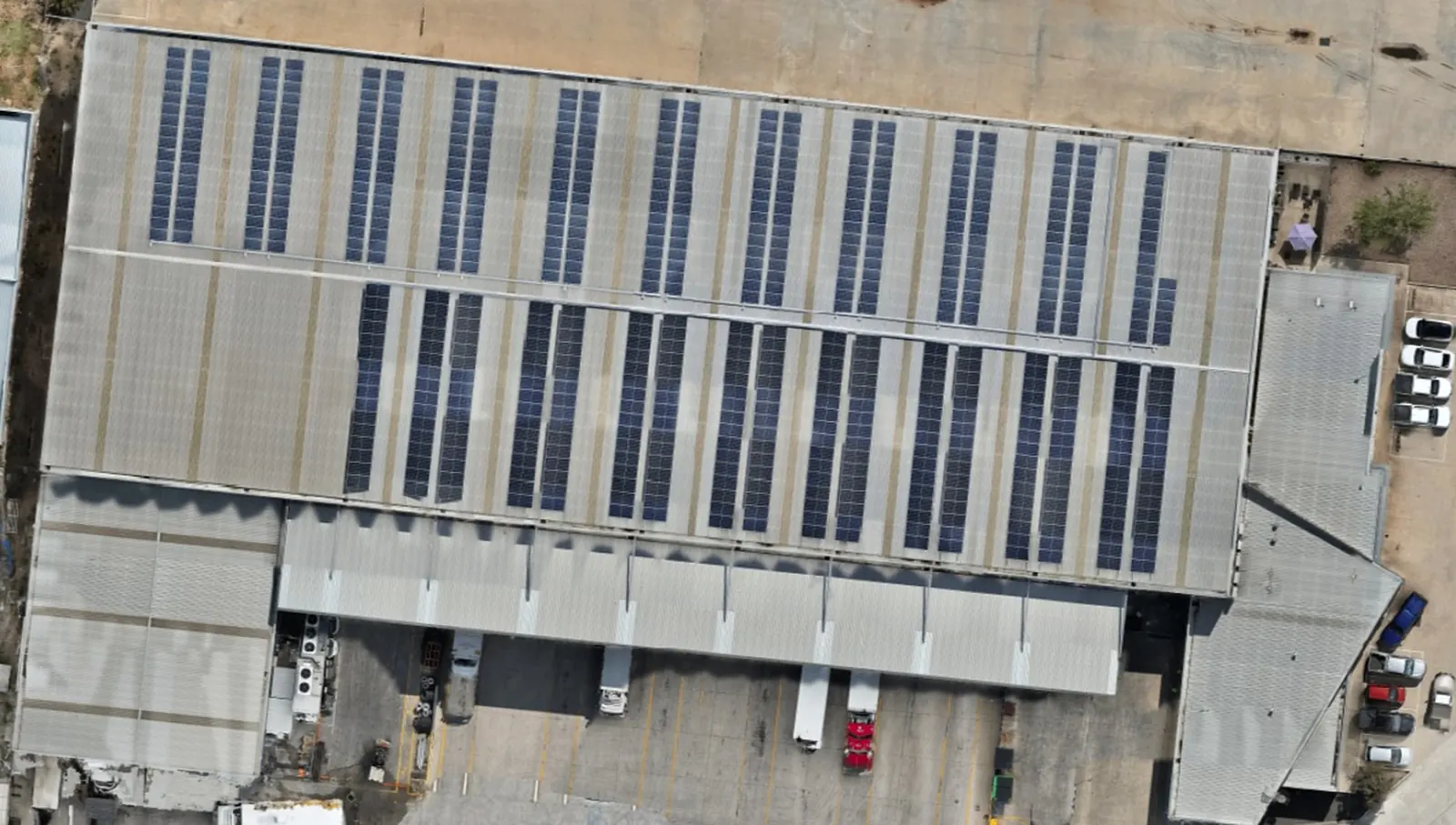 Colour aerial photo of Warehouse 1: a long commercial roof covered in rows of solar panels.