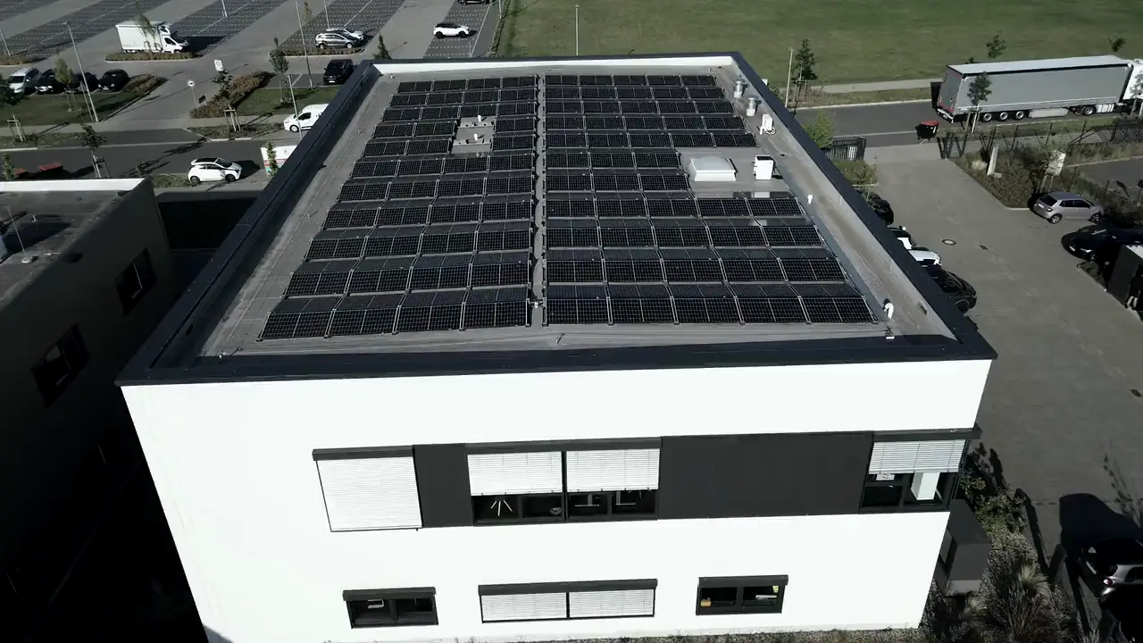 Stock aerial footage: a commercial building with a rooftop solar array.